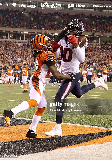 DeAndre Hopkins of the Houston Texans catches a pass for a touchdown while being defended by Adam Jones of the Cincinnati Bengals during the fourth...