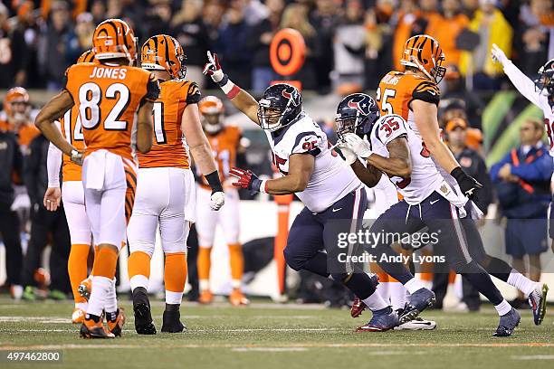 Christian Covington of the Houston Texans and Eddie Pleasant of the Houston Texans celebrate after A.J. Green of the Cincinnati Bengals lost a fumble...