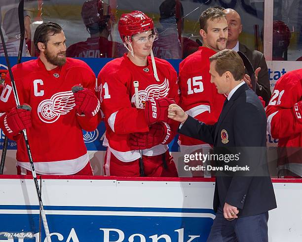 Former Detroit Red Wing forward and recent Hockey Hall of Fame inductee Sergei Fedorov pounds gloves with Dylan Larkin of the Wings prior to an NHL...