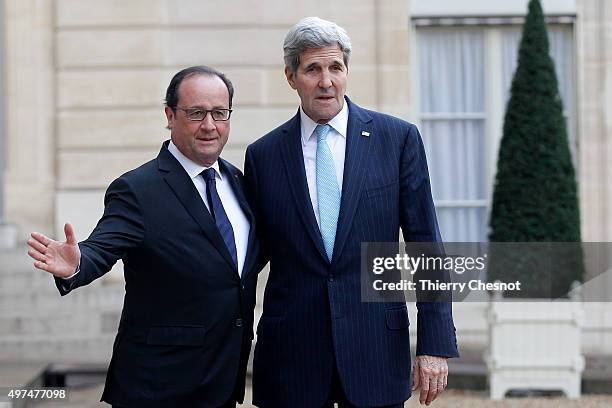 French President Francois Hollande welcomes US Secretary of State John Kerry prior to a meeting at the Elysee Presidential Palace on November 17,...