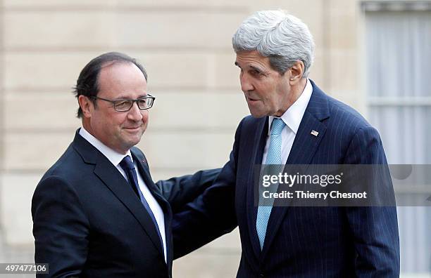 French President Francois Hollande welcomes US Secretary of State John Kerry prior to a meeting at the Elysee Presidential Palace on November 17,...