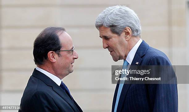 French President Francois Hollande welcomes US Secretary of State John Kerry prior to a meeting at the Elysee Presidential Palace on November 17,...