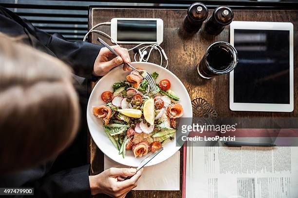 business woman having a break in a restaurant - long weekend australia stock pictures, royalty-free photos & images