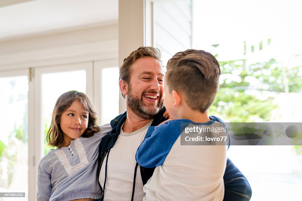 Happy father greeting his children