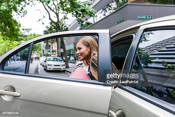 geschäftsfrau, die mit dem auto in der innenstadt - auto aussteigen stock-fotos und bilder