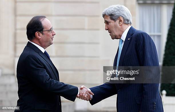 French President Francois Hollande welcomes US Secretary of State John Kerry prior to a meeting at the Elysee Presidential Palace on November 17,...