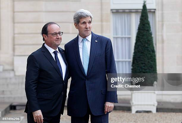 French President Francois Hollande welcomes US Secretary of State John Kerry prior to a meeting at the Elysee Presidential Palace on November 17,...