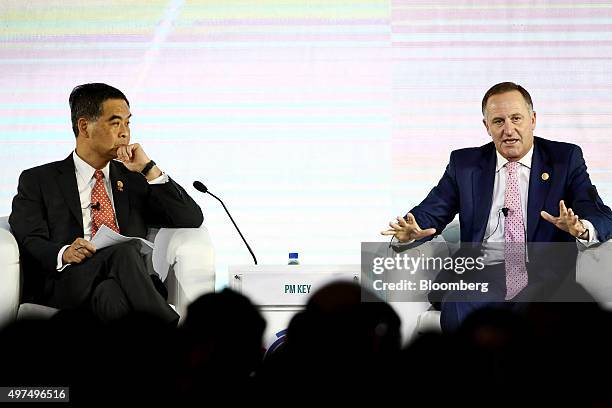 Leung Chun-ying, Hong Kong's chief executive, left, looks on as John Key, New Zealand's prime minister, speaks at the Asia-Pacific Economic...