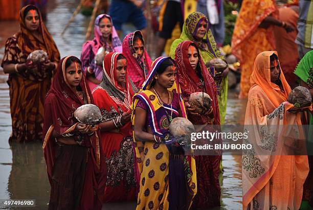 Indian Hindu devotees offer prayers during the 'Chhat Puja' on the banks of the Brahmaputra River in Guwahati on November 17, 2015. Devotees pay...