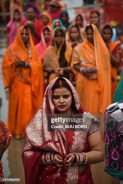 Indian Hindu devotees offer prayers during the 'Chhat Puja' on the banks of the Brahmaputra River in Guwahati on November 17, 2015. Devotees pay...