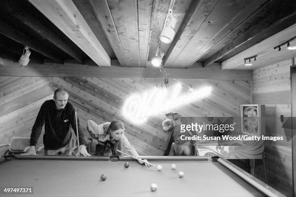 Former television producer Bruce Cooper watches as his wife, Dutch-born businesswoman and former model Wilhelmina Cooper lines up a shot at the...