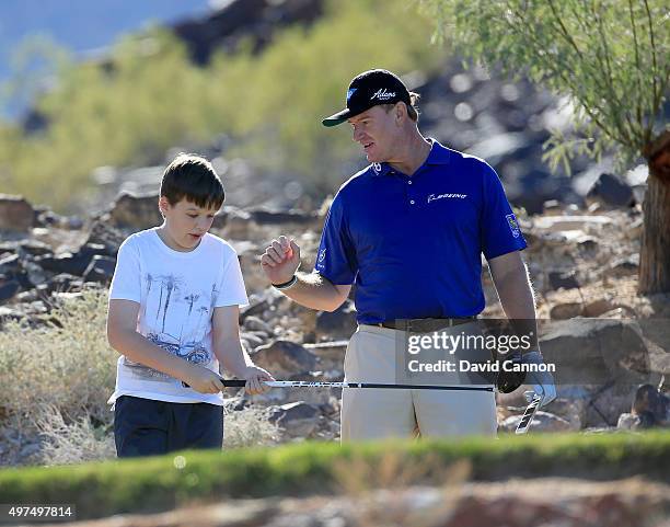 Ernie Els of South Africa with his son Ben Els during the SAP Invitational Golf Day at Dragon Ridge Country Club prior to the Els For Autism Grande...