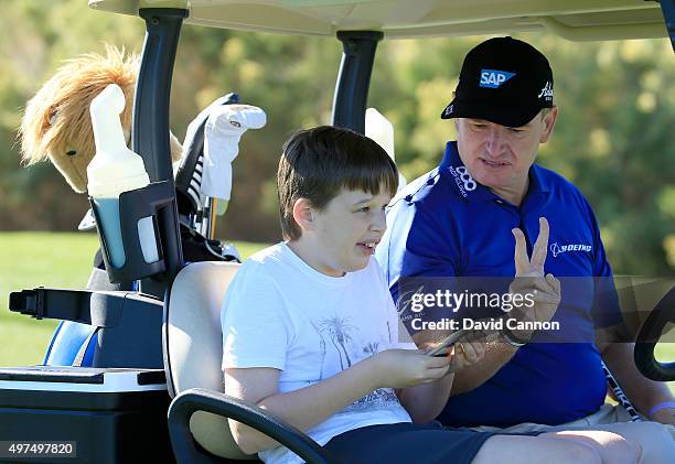 Ernie Els of South Africa with his son Ben Els during the SAP Invitational Golf Day at Dragon Ridge Country Club prior to the Els For Autism Grande...