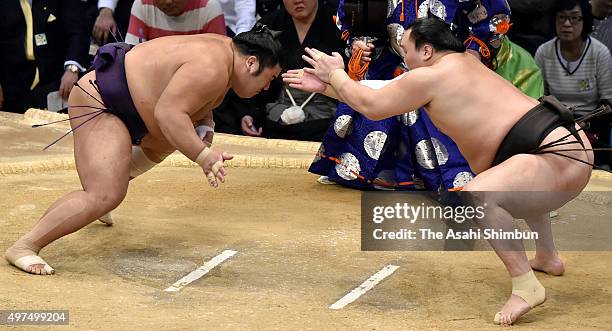 Mongolian yokozuna Hakuho claps his hands in front of Tochiozan during day ten of the Grand Sumo Kyushu Tournament at Fukuoka Convention Cetner on...