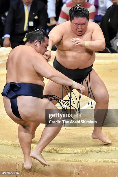 Ozeki Goeido pushes Mongolian yokozuna Kakuryu out of the ring during day ten of the Grand Sumo Kyushu Tournament at Fukuoka Convention Cetner on...