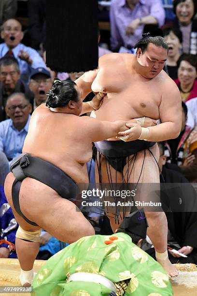 Toyonoshima pushes ozeki Kisenosato out of the ring to win during day ten of the Grand Sumo Kyushu Tournament at Fukuoka Convention Cetner on...