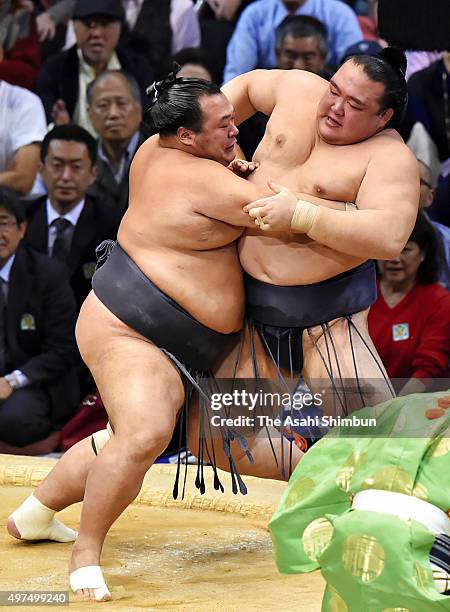 Toyonoshima pushes ozeki Kisenosato out of the ring to win during day ten of the Grand Sumo Kyushu Tournament at Fukuoka Convention Cetner on...