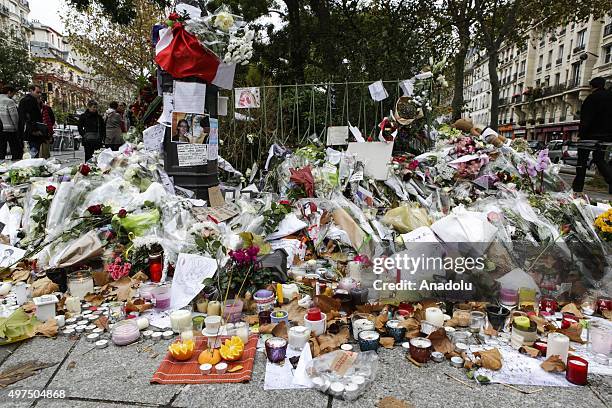 Flowers and candles are seen at the memorial for the victims of Paris terror attacks in front of Bataclan, Boulevard Voltaire in Paris, France on...