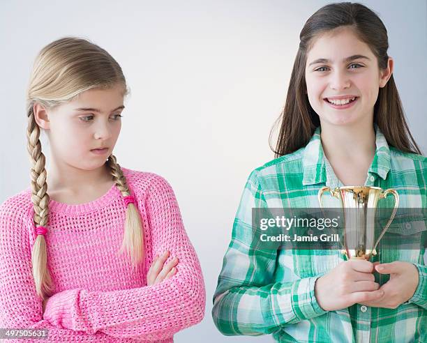 young girl jealous of friend's achievement - jealousy stock pictures, royalty-free photos & images