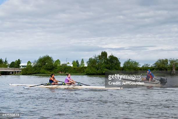 coaching a double scull on the fraser river - oar stock pictures, royalty-free photos & images