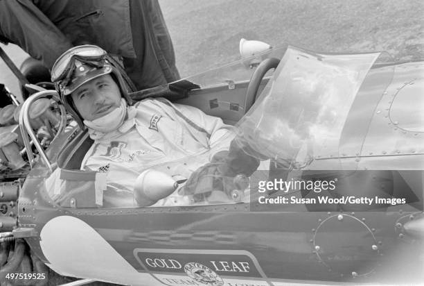 British racecar driver and team owner Graham Hill sits behind the wheel of his Formula One car, England, January 1970.