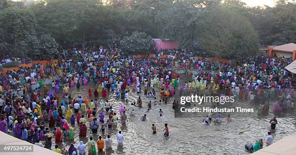 Thousands of devotees celebrate Chhath Puja, taking holy dip in the ponds and paying oblations to the setting sun at Sheetla Mata Mandir, on November...