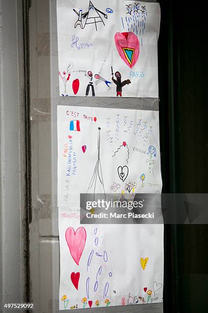 Tributes and flowers are left near the 'La Belle Equipe' restaurant on November 17, 2015 in Paris, France. Paris remains under heightened security...