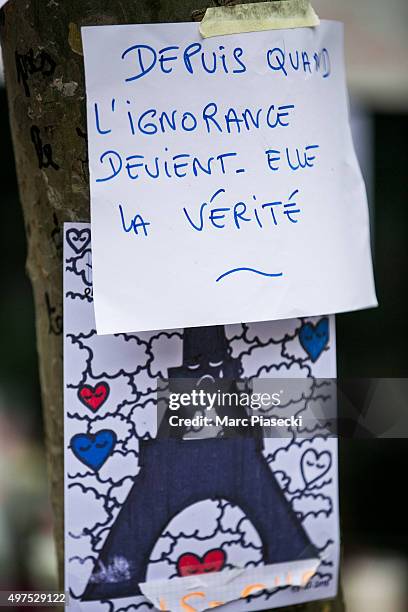 Tributes and flowers are left near the 'La Belle Equipe' restaurant on November 17, 2015 in Paris, France. Paris remains under heightened security...