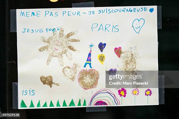 Tributes and flowers are left near the 'La Belle Equipe' restaurant on November 17, 2015 in Paris, France. Paris remains under heightened security...