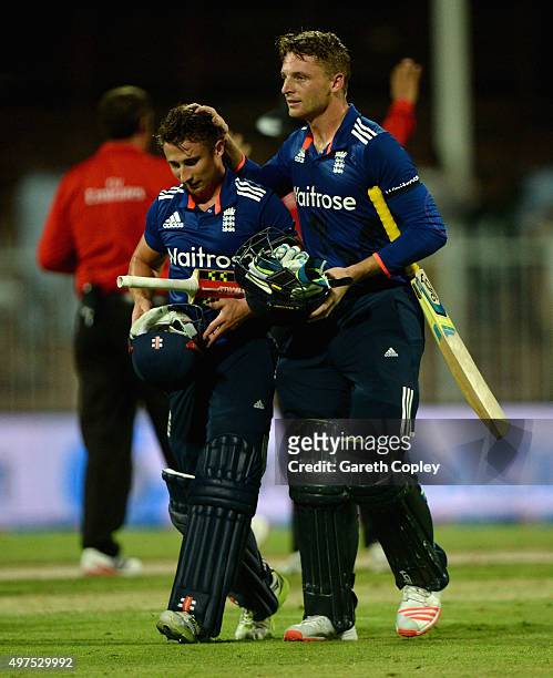 Jos Buttler and James Taylor of England celebrate after winning the 3rd One Day International match between Pakistan and England at Sharjah Cricket...