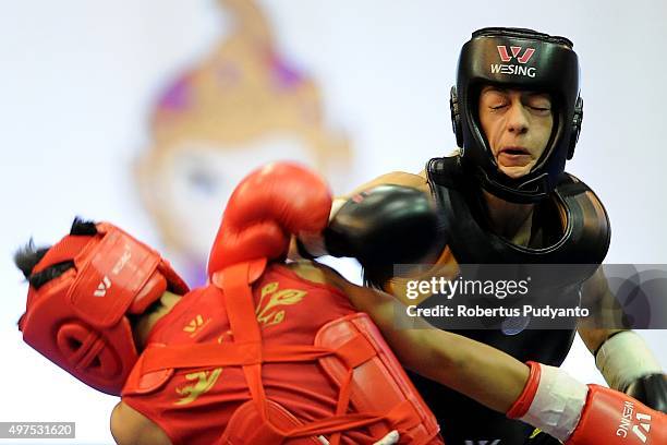Luan Zhang of China competes against Alice Aleluia Da Luz of Brazil in the semi-final Women's 52kg Sanda Competition during the 2015 World Wushu...