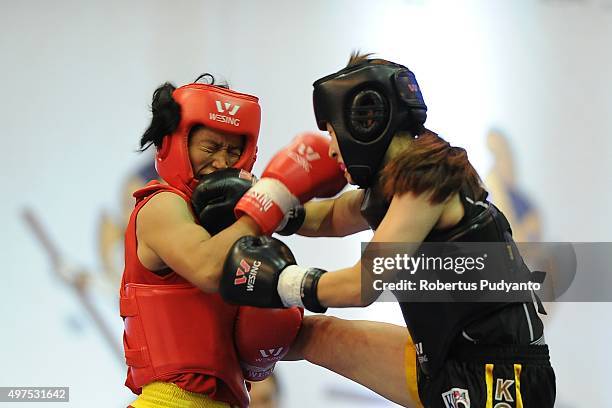 Sanathoi Devi Yumnam of India competes against Hyebin Kim of Korea in the semi-final Women's 52kg Sanda Competition during the 2015 World Wushu...