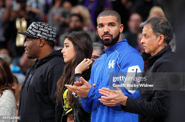 Anjali Ranadive, Canadian singer Drake and owner Vivek Ranadive of the Sacramento Kings watch the game between the San Antonio Spurs and Sacramento...