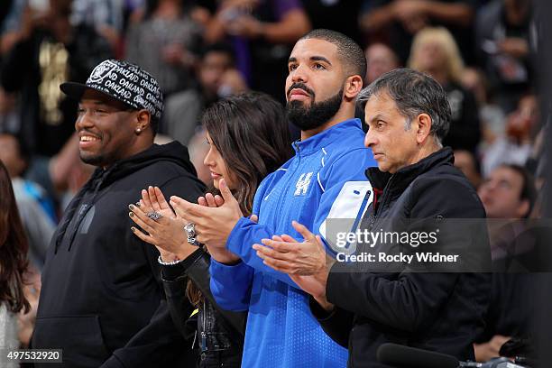 Anjali Ranadive, Canadian singer Drake and owner Vivek Ranadive of the Sacramento Kings watch the game between the San Antonio Spurs and Sacramento...