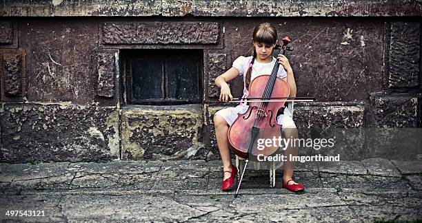 music of the street - girl cello stock pictures, royalty-free photos & images