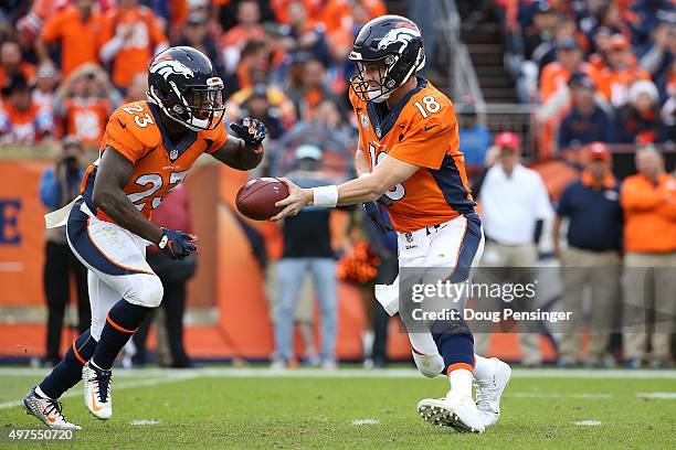 Quarterback Peyton Manning of the Denver Broncos hands the ball off to Ronnie Hillman of the Denver Broncos against the Kansas City Chiefs at Sports...