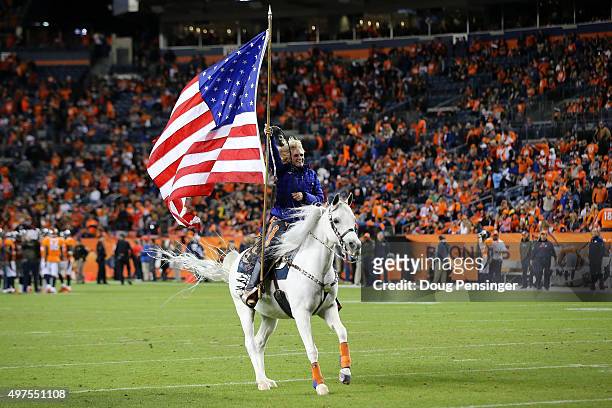 Thunder the mascot and Ann judge-Wegener celebrate a touchdown by the Denver Broncos against the Kansas City Chiefs at Sports Authority Field at Mile...