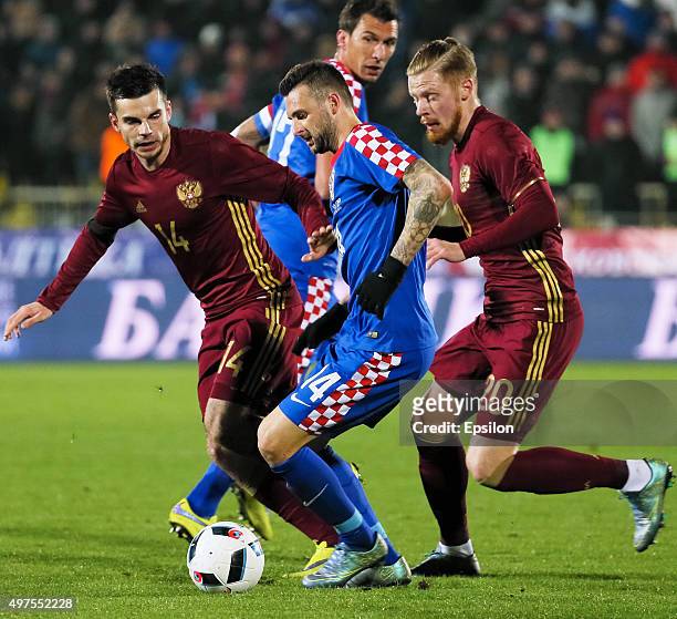 Artur Yusupov and Andrei Semyonov of Russia is challenged by Marcelo Brozovic of Croatia during the international friendly football match between...
