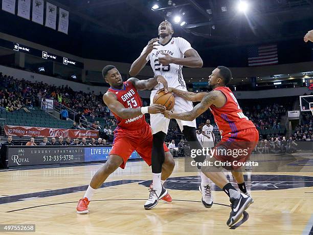 Cady Lalanne of the Austin Spurs has the ball stripped by Adonis Thomas and Ryan Boatright of the Grand Rapids Drive at the Cedar Park Center on...