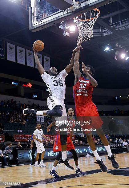 Youssou Ndoye of the Austin Spurs shoots over Henry Sims of the Grand Rapids Drive at the Cedar Park Center on November 17, 2015 in Cedar Park,...