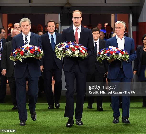 Roy Hodgson, manager of England, Prince William, The Duke of Cambridge and Didier Deschamps and Head Coach of France carry out floral tributes prior...