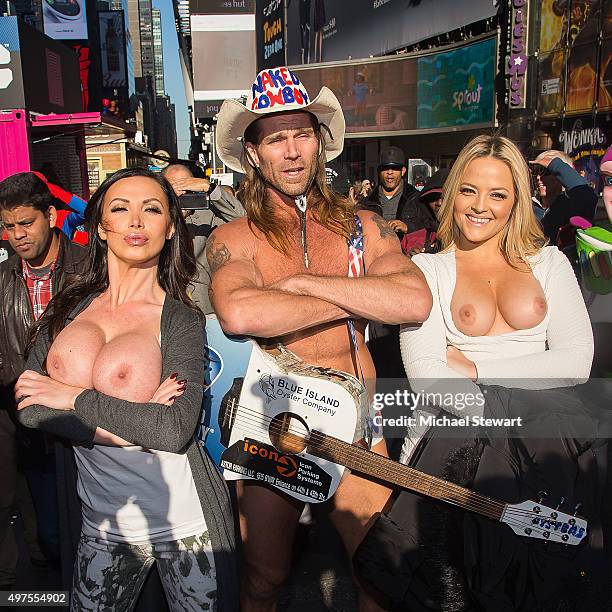 Adult actresses Nikki Benz and Alexis Texas pose topless with the Naked Cowboy in celebration of gender liberation in Times Square on November 17,...