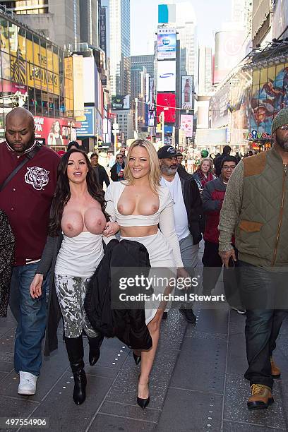 Adult actresses Nikki Benz and Alexis Texas walk topless through Times Square in celebration of gender liberation on November 17, 2015 in New York...