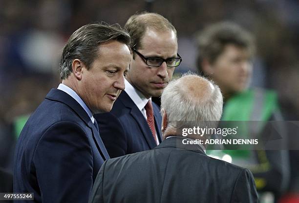 Britain's Prime Minister David Cameron and Britain's Prince William are pictured before the start of the friendly football match between England and...