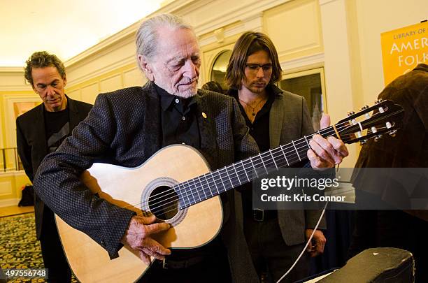 Willie Nelson check out artifacts after attending the 2015 Gershwin Prize Luncheon where he was honored with a certificate and an American flag in...