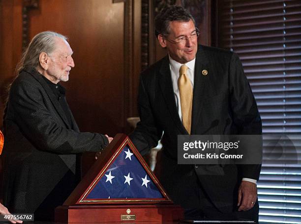 Representative Gregg Harper present Willie Nelson with an American Flag during the 2015 Gershwin Prize Luncheon Honoring Willie Nelson in the Thomas...