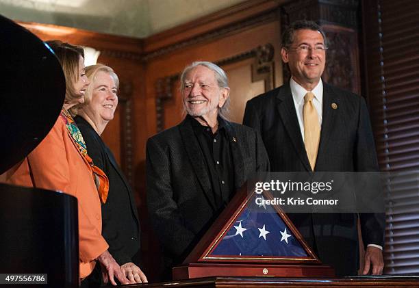 Representative Gregg Harper present Willie Nelson with an American Flag during the 2015 Gershwin Prize Luncheon Honoring Willie Nelson in the Thomas...