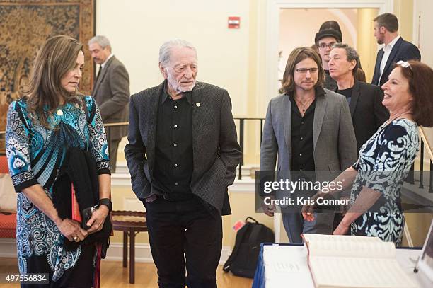 Willie Nelson with wife Annie D'Angelo, sons Lukas Nelson and Micah Nelson check out artifacts after attending the 2015 Gershwin Prize Luncheon where...