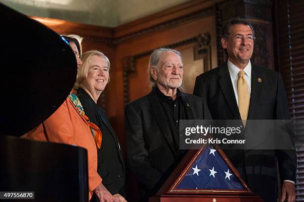 Representative Gregg Harper present Willie Nelson with an American Flag during the 2015 Gershwin Prize Luncheon Honoring Willie Nelson in the Thomas...