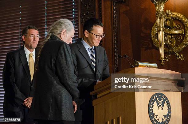 Acting Librarian of Congress David Mao and Rep. Gregg Harper present Willie Nelson with a certificate during the 2015 Gershwin Prize Luncheon...